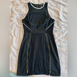 Mini Bodycon Black Dress with Lace detailing and Gold zippers.